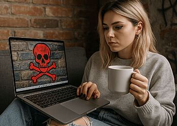 Windows ネットワーク保護 - コンピュータ ウイルスによって赤いドクロのシンボルが表示されたラップトップを見つめる心配そうな女性。ハッカーやマルウェアを防ぐために Windows でネットワーク保護を有効にすることの重要性を示しています。