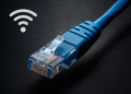 Domina Cables CAT Ethernet RJ45-kabel närbild, blå höghastighets-LAN-nätverkskabel på mörk bakgrund för pålitlig trådbunden internetanslutning.